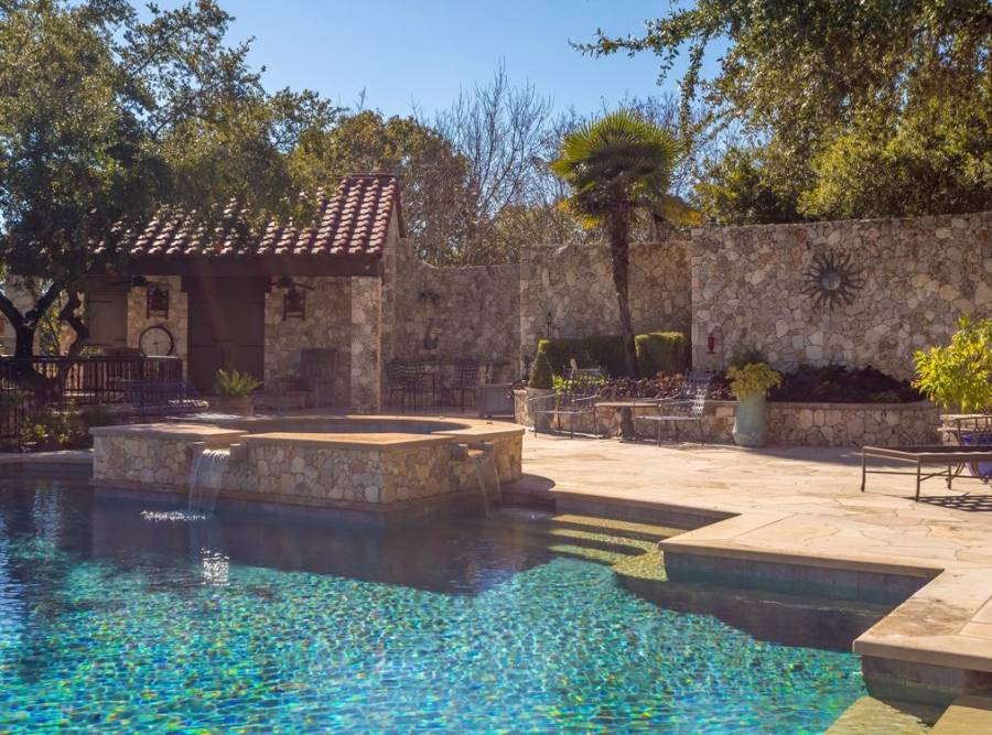 Resort pool deck framed by Maven-maintained landscaping